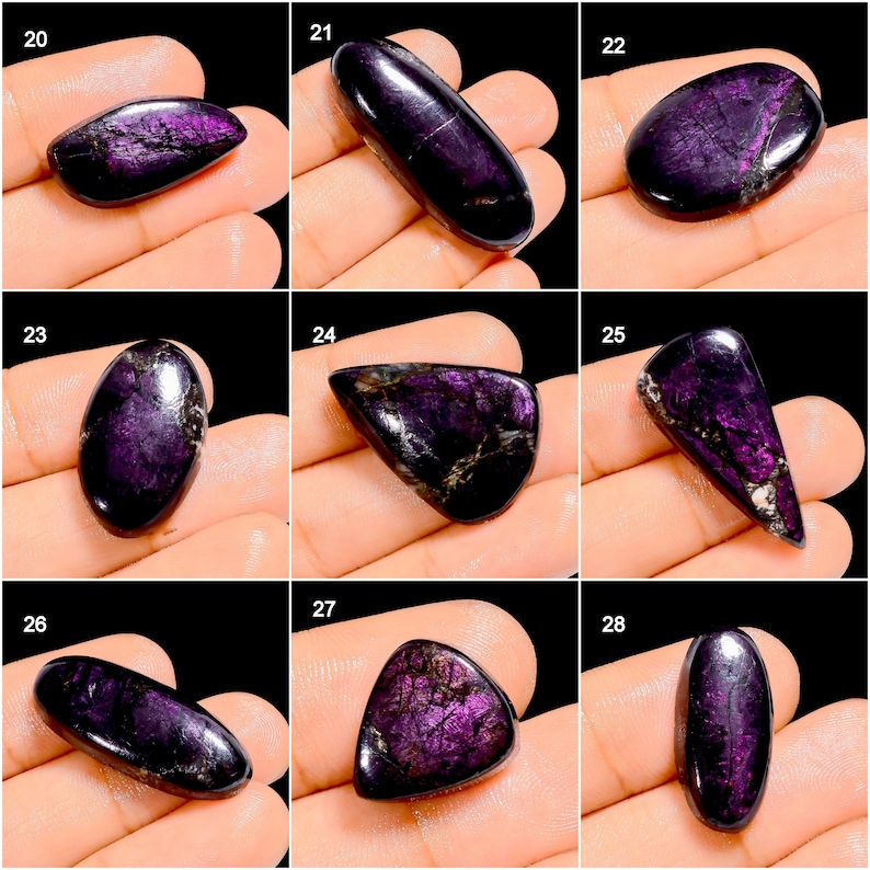 May include: A collection of polished, purple charoite gemstones in various shapes. The stones display a range of dark purple hues with swirling patterns and a glossy finish. Each stone is held in a hand, showcasing the natural beauty and unique characteristics of the gemstones.