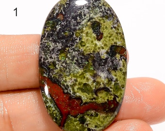 May include: A green, black, and red oval cabochon gemstone with a mottled pattern.