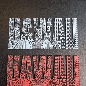 May include: Two rectangular wooden signs with the word "HAWAII" in large, stylized letters. One sign is red with black detailing, the other is light blue with black detailing. The word "KING" is vertically aligned.