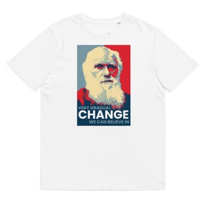 May include: White t-shirt with a red, white, and blue graphic of Charles Darwin with the text "Very Gradual Change We Can Believe In."