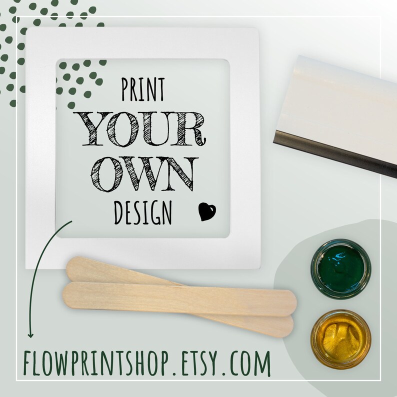 May include: A white frame with the text "PRINT YOUR OWN DESIGN" inside. Two wooden craft sticks, two small jars of paint, a squeegee, and the website "FLOWPRINTSHOP.ETSY.COM" are also shown.