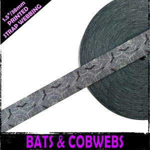 May include: 1.5 inch wide black and white printed webbing with a pattern of bats and cobwebs. The text "Bats & Cobwebs" is printed on the bottom of the image.  The text "1.5"/38mm PRINTED STRAP WEBBING" is printed in pink on the top left corner of the image.
