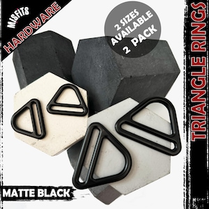 May include: A selection of matte black triangle rings, sold as a 2-pack, presented on geometric shapes. The image features the text "Misfits Hardware" and "Triangle Rings". A circular graphic states "2 sizes available".