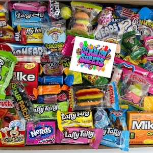 May include: A box filled with a variety of colourful candies, including gummy candies, sour candies, hard candies, and chocolate candies. The box includes brands like Laffy Taffy, Nerds, Mike and Ike, Sour Patch Kids, and Hot Dog.