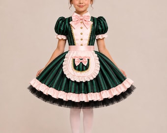 May include: A dark green and black striped dress featuring a light pink collar with a bow, puff sleeves, and a matching apron with a small bow. The skirt has a ruffled pink hem over a black tulle layer, paired with white tights and black shoes.