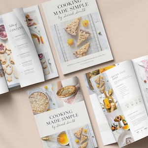 May include: An open cookbook titled "Cooking Made Simple" by Sarah Smith. The cover features a collage of photos of various baked goods, including a pie, a tart, and a crumble. The book is open to a page with a recipe titled "Recipe Title Here".