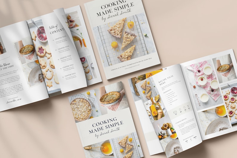 May include: An open cookbook titled "Cooking Made Simple" by Sarah Smith. The cover features a collage of photos of various baked goods, including a pie, a tart, and a crumble. The book is open to a page with a recipe titled "Recipe Title Here".