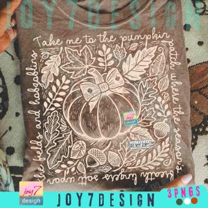 May include: A brown t-shirt with a white graphic design featuring a pumpkin with a bow, surrounded by leaves and acorns. The text reads "Take me to the pumpkin patch where the season's breath lingers soft upon the fields and hobgoblins."