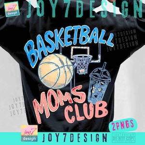 May include: Black sweatshirt with a basketball-themed graphic. The design features a basketball, hoop, and a drink with ice. Text includes "BASKETBALL" in blue and "MOMS CLUB" in pink.