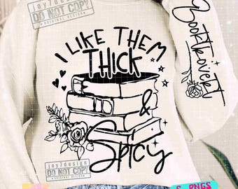 May include: Cream-colored sweatshirt with a black graphic design featuring stacked books, hearts, stars, and floral elements. The text reads "I Like Them Thick & Spicy" and "Booklover" on the sleeve. The design includes SVG, PNG, DXF, EPS, and PDF files.