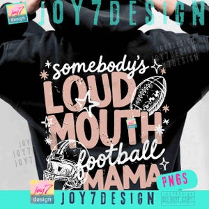 May include: A black hooded sweatshirt featuring a graphic design on the back with the text "somebody's LOUD MOUTH football MAMA". The design includes a football, a football helmet, and star accents in light pink and white with a distressed texture.
