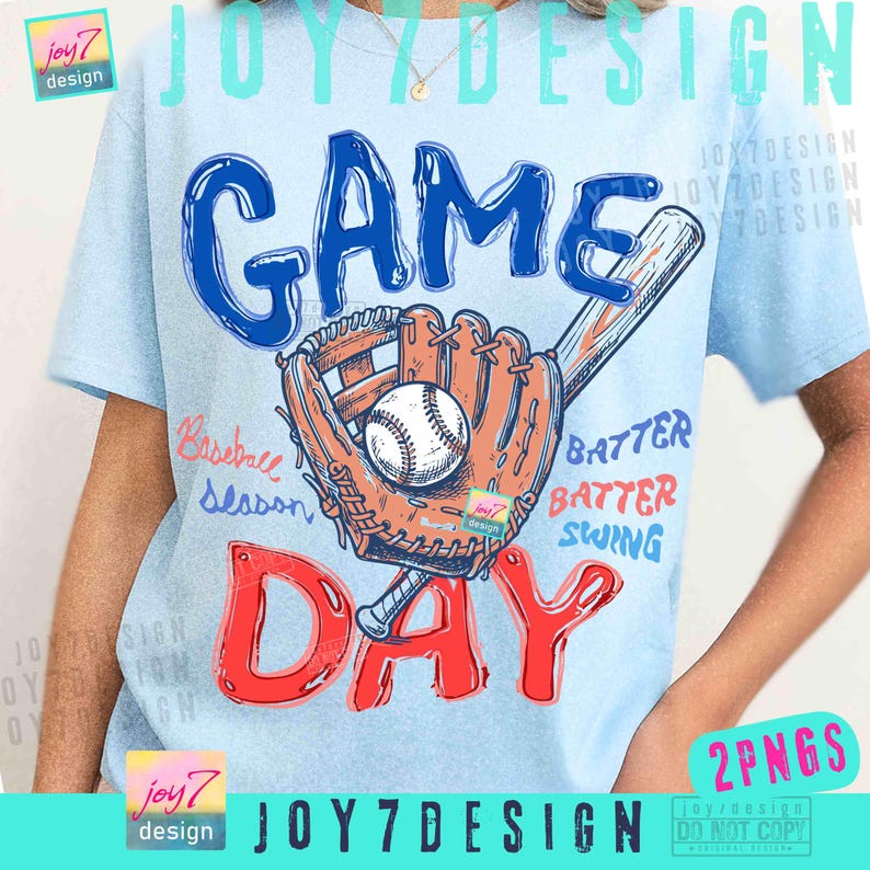 May include: Light blue t-shirt with a baseball-themed graphic. The design features the words "GAME DAY" in blue and red, a baseball glove, a baseball, and a bat. Additional text includes "Baseball Season", "Batter, Batter, Swing".