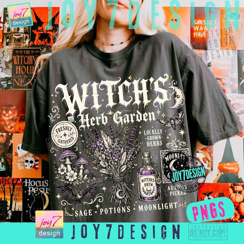May include: A dark gray t-shirt featuring a graphic print with the text "WITCH'S Herb Garden". The design includes illustrations of a lavender bouquet, mushrooms, a bat, a moth, and a glass bottle labeled "WITCHES BREW" with stars and moon motifs.