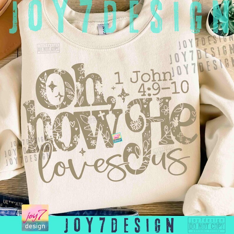May include: Cream-colored sweatshirt with the text "Oh, how He loves us" in a decorative font. The text includes the Bible verse 1 John 4:9-10. The design features floral and star accents.