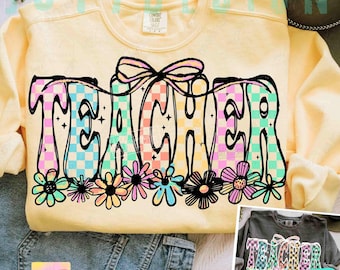 May include: A light yellow sweatshirt with the word "TEACHER" in a colorful, checkered design. The word is outlined in black and adorned with a bow and floral accents. The design includes the text "JOY 7 DESIGN 2 PNGS".