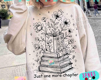 May include: Cream-colored sweatshirt featuring a black and white illustration of a stack of books with flowers growing out of the top book. The text "Just one more-chapter" is below the books. The design includes stars.