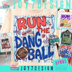 May include: A beige t-shirt featuring a graphic print with the text RUN THE DANG BALL in red and blue bubble letters. The design includes a brown football, a red bow, a red heart, and a checkered pattern against a background of light blue stripes.