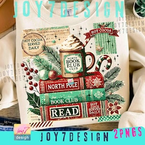 May include: Cream-colored sweatshirt with a festive graphic featuring a mug of hot cocoa topped with whipped cream, stacked books, and holiday decorations. The graphic includes the text "Hot Cocoa Served Daily," "North Pole," "Book Club," and "Read."
