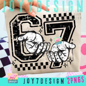 May include: A beige sweatshirt featuring a distressed black graphic of the number 67 with two hands holding the number. The design includes a checkered pattern and star accents. The text "JOY7DESIGN 2PNGS" is at the bottom.