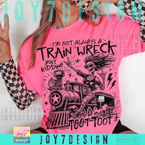 May include: A bright pink long-sleeved shirt with a black graphic of a train and a skeleton wearing sunglasses. The text reads "I'm not always a train wreck, just kidding" and "Toot Toot".