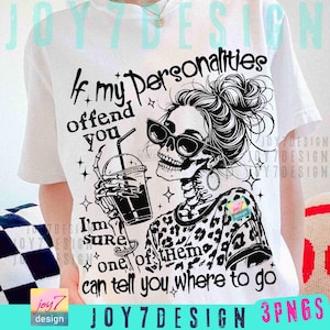 May include: White t-shirt with a graphic of a skeleton wearing sunglasses and a leopard print top, holding a drink. Text reads "If my personalities offend you, I'm sure one of them can tell you where to go."