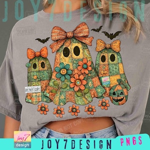 May include: A gray t-shirt featuring a Halloween-themed design. The design includes three ghost figures with patchwork patterns, bows, and flowers. The image also includes bats and the text "JOY7DESIGN PNGS".