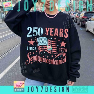 May include: Black sweatshirt with a graphic design celebrating the 250th anniversary since 1776. The design includes the text "250 YEARS", an American flag, stars, and the word "Semiquincentennial".