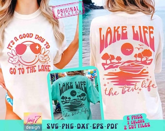 May include: Cream-colored t-shirts with lake-themed graphics. One shirt features a smiley face with sunglasses and the text "It's a good day to go to the lake." The other shirt has "Lake Life" and a boat graphic.