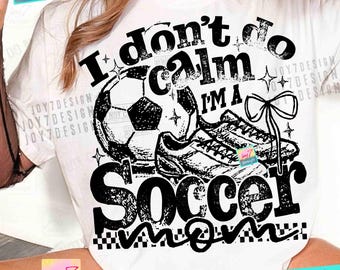May include: White t-shirt with a black graphic design. The design includes a soccer ball, cleats, and the text "I don't do calm I'm a Soccer Mom." The design also includes stars and a bow.