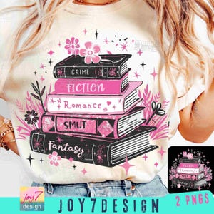 May include: Cream-colored t-shirt featuring a stack of books with the words "Crime", "Fiction", "Romance", "Smut", and "Fantasy" in black and pink. The design includes floral and star accents. The text "JOY7DESIGN" is at the bottom.