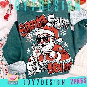 May include: A teal sweatshirt with a graphic of Santa Claus wearing sunglasses and the text "Santa Says Six Seven". The Santa graphic is red, white, and black. Snowflake and checkerboard patterns are also present.