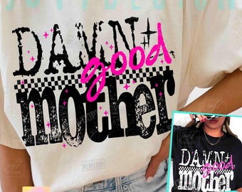 May include: Cream-colored t-shirt with the text "DAMN good mother" in black, pink, and white. The design includes a checkered pattern and pink star accents. The shirt is a casual wear item.