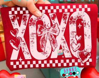 May include: A red fabric item with the text "XOXO" in a distressed white font, along with a bow and hearts. The design includes a checkered border and small stars. The item is held by a hand.