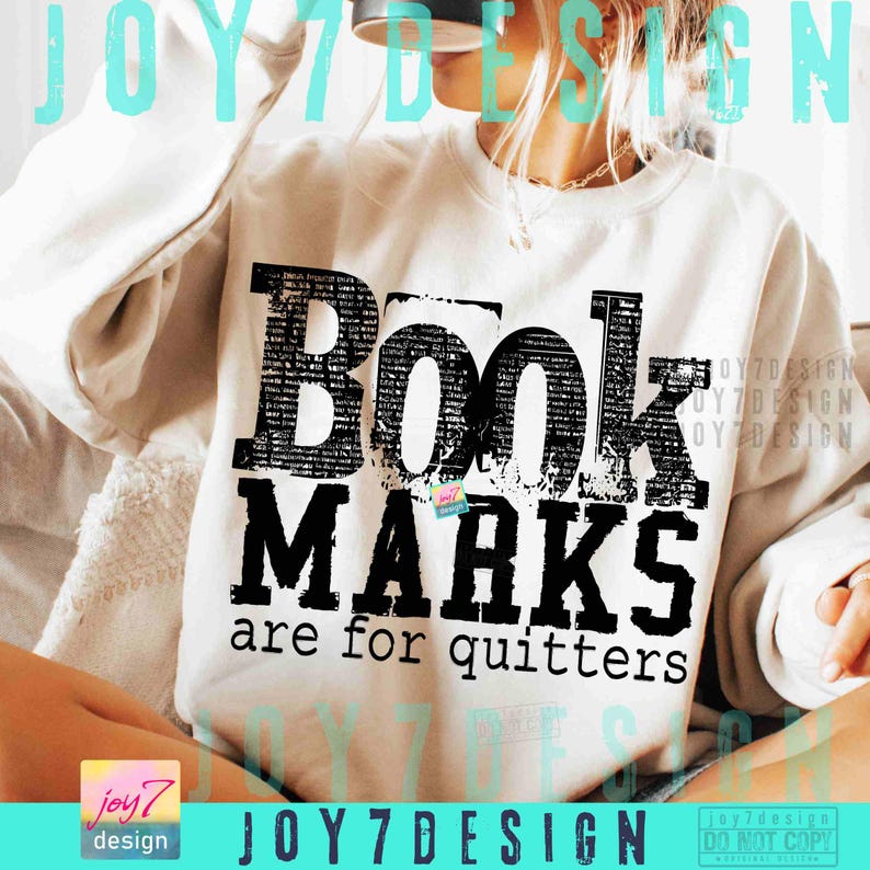 May include: White sweatshirt with the text "Book Marks are for quitters" in black block letters. The word "Book" is filled with a newspaper-like pattern. The sweatshirt has long sleeves.
