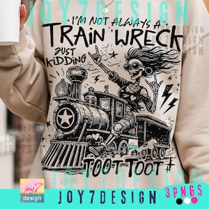 May include: Beige sweatshirt with a black and white graphic of a skeleton riding a train. The text reads "I'm not always a train wreck, just kidding" and "Toot Toot". The train has a star on the front.