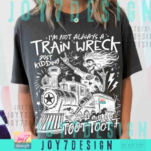 May include: Dark gray t-shirt with a white graphic of a train and a skeleton wearing glasses. Text on the shirt reads "I'm not always a train wreck, just kidding." The train has a star on the front and the words "toot toot" below.