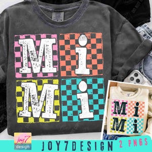 May include: Dark grey t-shirt featuring the word "MiMi" in a four-square design. Each square has a different coloured background: pink, orange, yellow, and blue, with a checkered pattern. The letters are white with a distressed appearance.