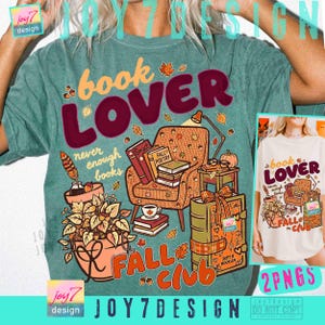 May include: A mineral-washed green t-shirt featuring a graphic print with the text book LOVER and FALL CLUB. The design includes an armchair, stacks of books, a potted plant, a lamp, and autumn leaves in shades of orange, brown, and yellow.