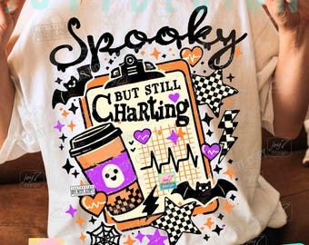 May include: White t-shirt with a Halloween-themed graphic. The design includes the words "Spooky But Still Charting" with a clipboard, coffee cup, bats, stars, and hearts. The shirt has a fun, festive design.