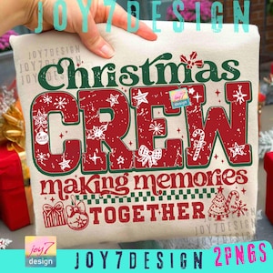 May include: A beige cushion featuring the text "Christmas CREW making memories TOGETHER" in red and green. The design incorporates festive elements like stars and snowflakes. The cushion is held by a hand.