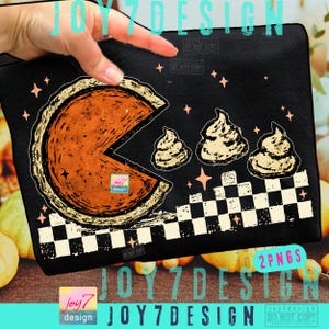 May include: Black zippered pouch featuring a pumpkin pie slice design with whipped cream and star accents. The design includes the text "JOY7DESIGN" and "2PNGS". The pouch has a checkered border.