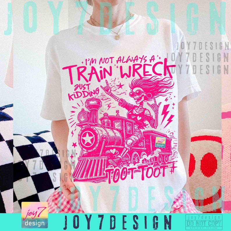May include: White t-shirt with a pink graphic of a train and a skeleton with the text "I'M NOT ALWAYS A TRAIN WRECK JUST KIDDING TOOT TOOT". The design includes a train, lightning bolts, and stars.