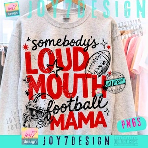 May include: A light gray crewneck sweatshirt featuring a graphic print with the text somebody's LOUD MOUTH football MAMA in red and black lettering. The design includes illustrations of a football and a football helmet with star accents.
