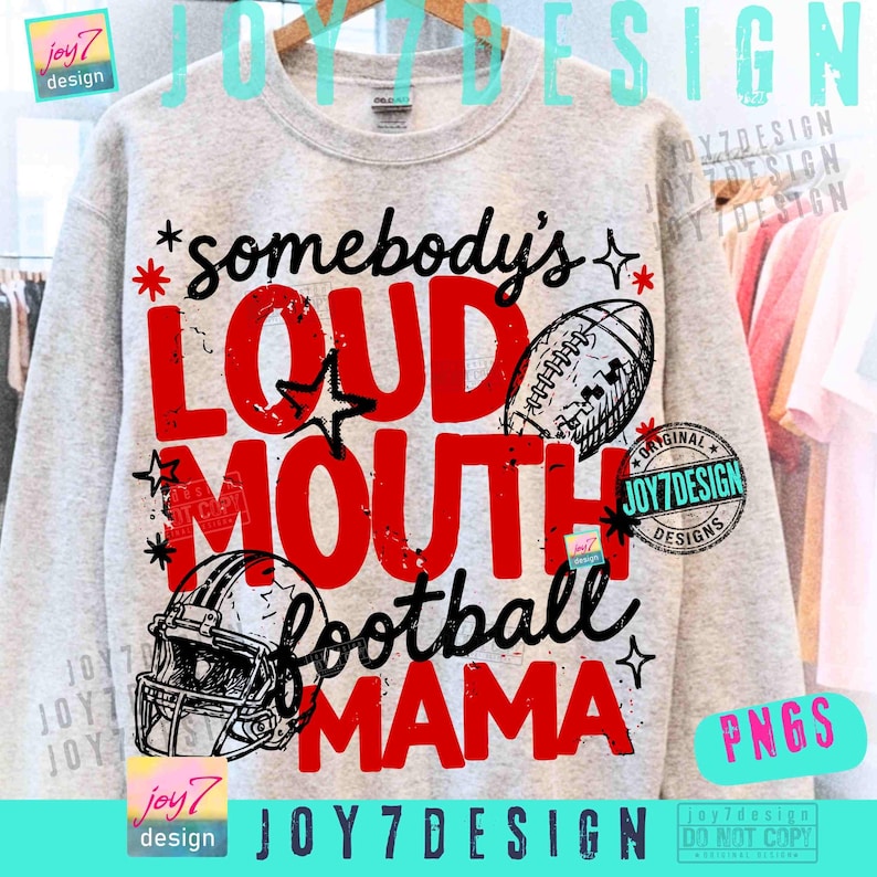May include: A light gray crewneck sweatshirt featuring a graphic print with the text somebody's LOUD MOUTH football MAMA in red and black lettering. The design includes illustrations of a football and a football helmet with star accents.
