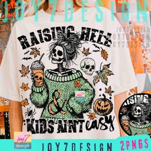 May include: Cream-colored t-shirt with a Halloween-themed graphic. The design features a skeleton wearing a green sweater, holding a coffee cup with a skull, and the text "RAISING HELL KIDS AIN'T EASY". Includes bats, leaves, and a pumpkin.
