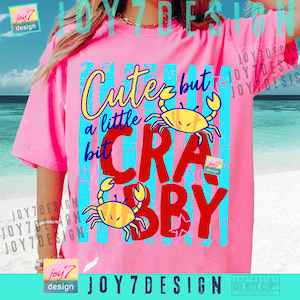 May include: Pink t-shirt with the text "Cute but a little crabby" in yellow, blue, and red. The design includes two yellow cartoon crabs. The shirt has short sleeves.
