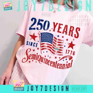 May include: A light pink t-shirt featuring a patriotic design. The design includes the text "250 YEARS SINCE 1776 SemiQuincentennial" in red and blue, along with an American flag and stars.