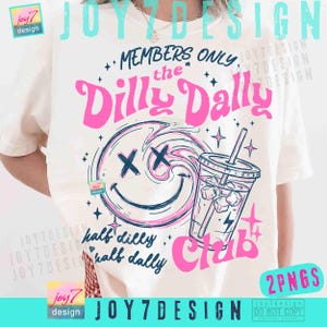 May include: White t-shirt with a graphic design featuring a smiley face with an 'XX' eye design, a drink with ice cubes, and the text "Members Only the Dilly Dally Club". The design is in pink and blue.