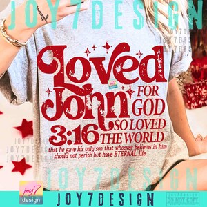 Op de afbeelding: Lichtgrijs t-shirt met een grote rode opdruk. De opdruk bevat de woorden "Loved John 3:16 For God So Loved The World", evenals een Bijbelvers: "that he gave his only son that whoever believes in him should not perish but have ETERNAL life."