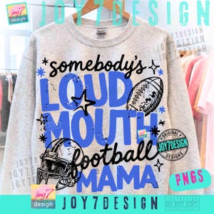 May include: A light gray crewneck sweatshirt featuring a graphic print with the text somebody's LOUD MOUTH football MAMA. The design includes a black and white football, a football helmet, and star accents in blue and black ink on the front.